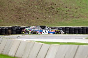 Ben Rhodes' Chevy Camaro slides off into the tires at turn 7.