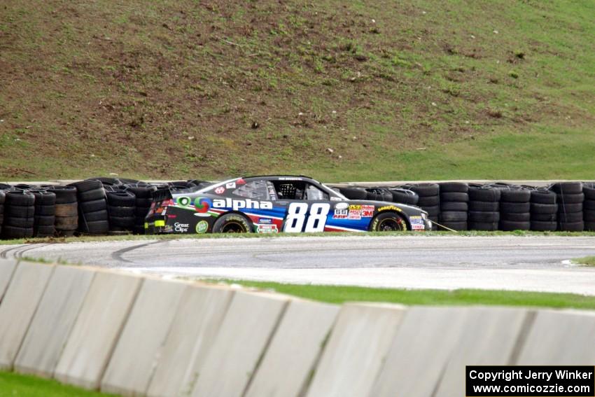 Ben Rhodes' Chevy Camaro slides off into the tires at turn 7.