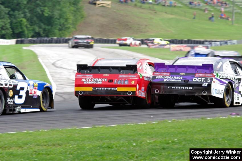 Michael Self's Chevy Camaro nudges Justin Marks' Chevy Camaro as Ty Dillon's Chevy Camaro follows.