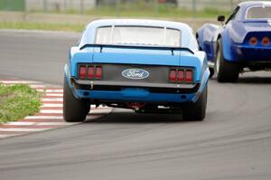 Brian Kennedy's Ford Mustang Boss 302 chases Kent Burg's Chevy Corvette