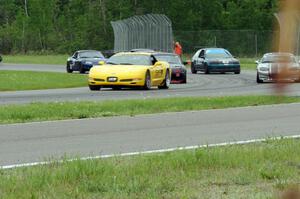 The pace car brings Race Group 1 through the carousel as the rain starts.