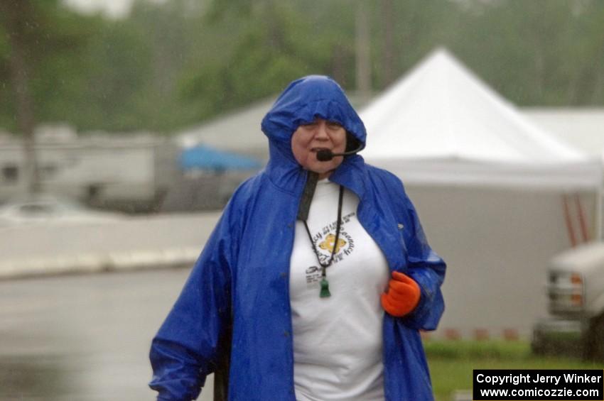 Karen Carson works the false grid while trying to keep dry in the pouring rain.