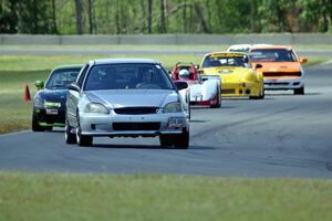 Nicholas Anderson's HPD Honda Civic leads the pack into turn 4.