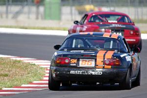 Alex Adams' HPDE3 Mazda Miata chases Nick Scott's SU Mazda Piata MK. III