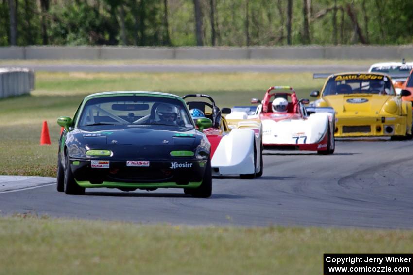 Aaron Jongbloedt's PTE Mazda Miata leads the pack into turn 4.