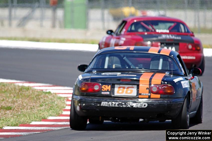 Alex Adams' HPDE3 Mazda Miata chases Nick Scott's SU Mazda Piata MK. III