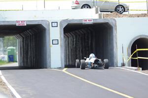 Bruce Drenth's AAR Eagle Formula Ford drives through the new tunnel that leads from the post-race inspection area to the paddock