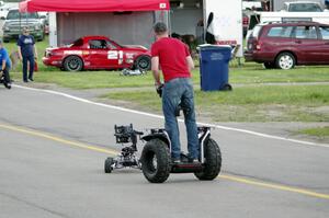 A film crew does a low-level shot of cars leaving the grid.