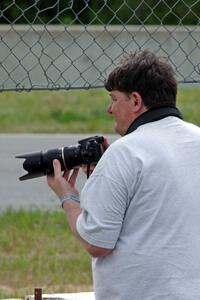 Stacy Scharch shoots from the hole in the turn 5 fence.