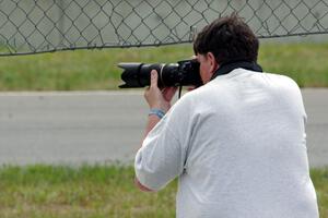 Stacy Scharch shoots from the hole in the turn 5 fence.