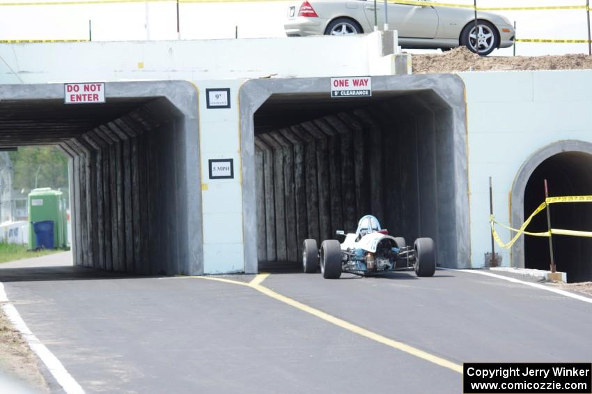 Bruce Drenth's AAR Eagle Formula Ford drives through the new tunnel that leads from the post-race inspection area to the paddock