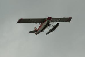 A floatplane flies over turn 2 during the race.