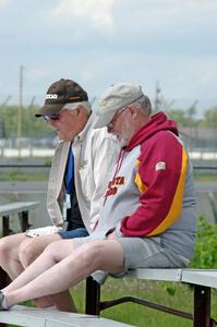 Zane Emstad and Don Haaversen watch the races from the bleachers at turn 3.