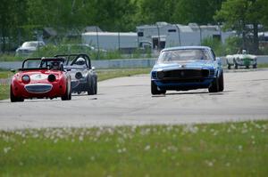 Brian Kennedy's Ford Mustang Boss 302 passes Tom Daly's and Phil Schaefer's Austin-Healey Sprites