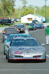 Bill Collins' T2 Chevy Corvette at the front of the grid for Race Group 5.