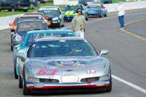 Bill Collins' T2 Chevy Corvette at the front of the grid for Race Group 5.