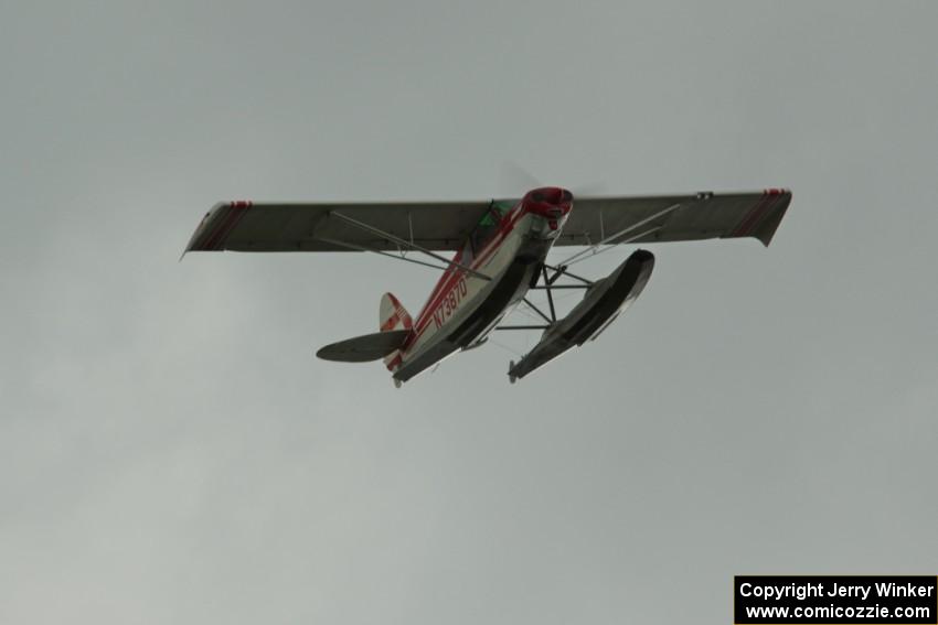 A floatplane flies over turn 2 during the race.