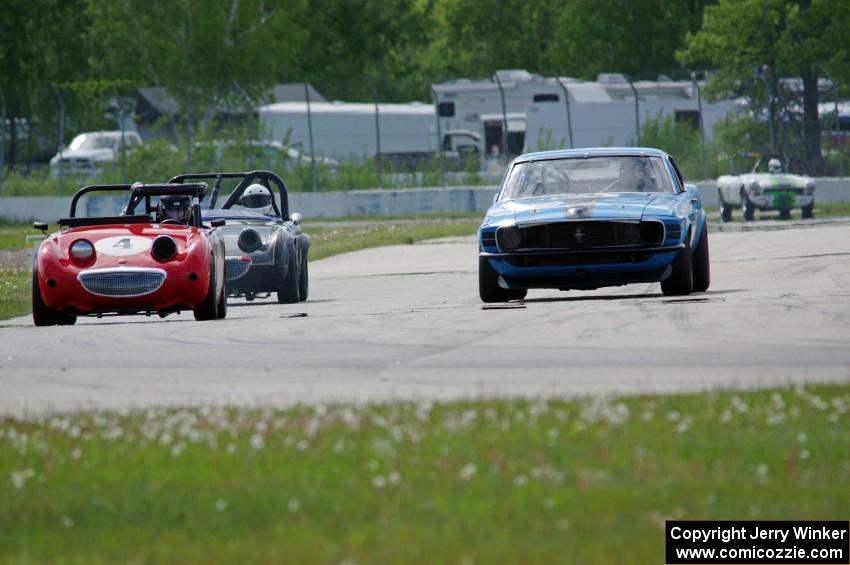 Brian Kennedy's Ford Mustang Boss 302 passes Tom Daly's and Phil Schaefer's Austin-Healey Sprites