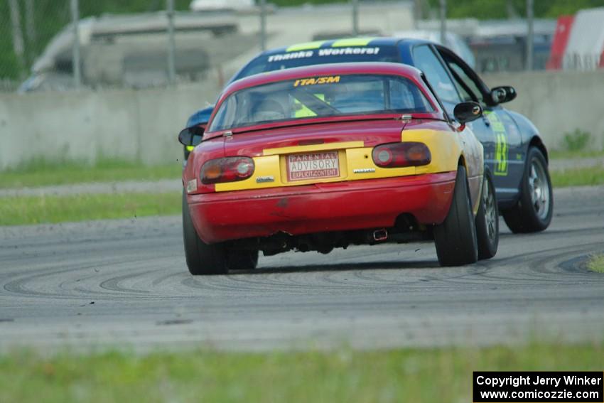 Greg Youngdahl's ITA Mazda Miata chases John Glowaski's ITA Dodge Neon ACR