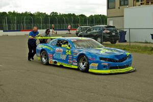 Tommy Archer's Chevy Camaro is pushed through the paddock after the race.