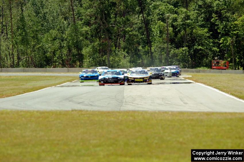 First lap: Lawrence Loshak's Chevy Camaro passes Tony Buffomante's Ford Mustang for the lead out of turn 3 into turn 4.