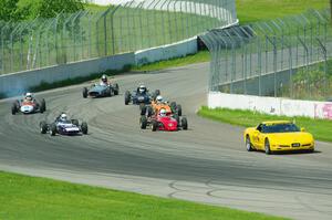 The field streams into turn ten on the pace lap.