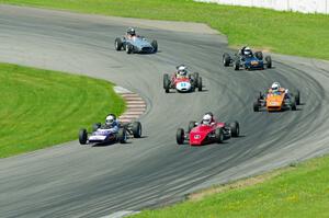 The field streams into turn eleven on the pace lap.