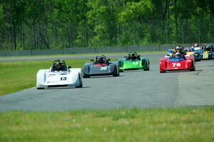 The field streams into turn four on the first lap.