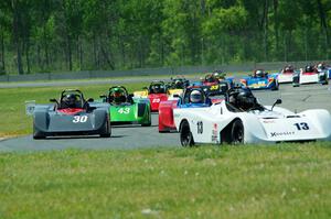 The field streams into turn four on the first lap.