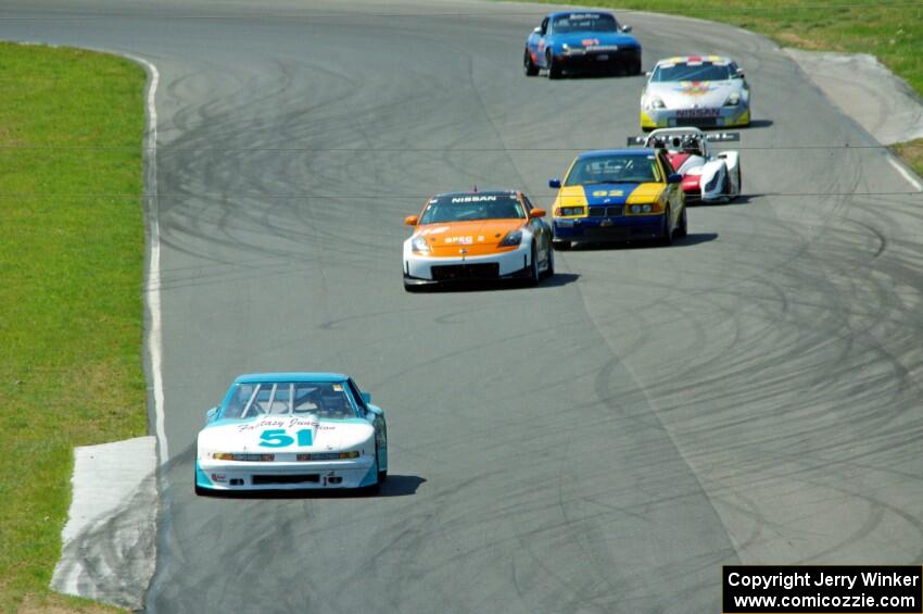 The front portion of the field comes through turns five and six on the first lap.