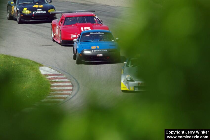 Doug Karon's GT-3 Nissan 350Z, Gordon Kuhnley's Spec Miata Mazda Miata, Ed Dulski's GT-1 Olds Cutlass Supreme and Greg Youngdahl