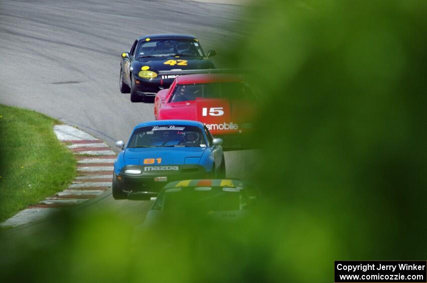 Doug Karon's GT-3 Nissan 350Z, Gordon Kuhnley's Spec Miata Mazda Miata, Ed Dulski's GT-1 Olds Cutlass Supreme and Greg Youngdahl