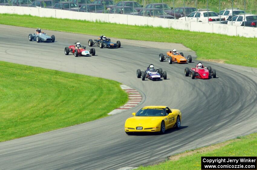 The field streams into turn eleven on the pace lap.