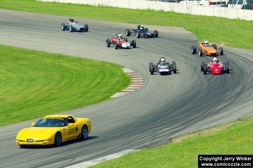 The field streams into turn eleven on the pace lap.