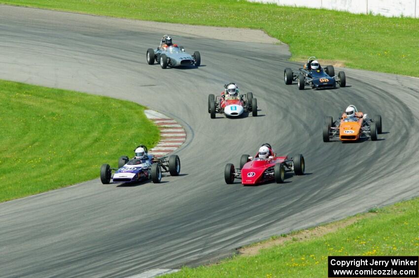 The field streams into turn eleven on the pace lap.