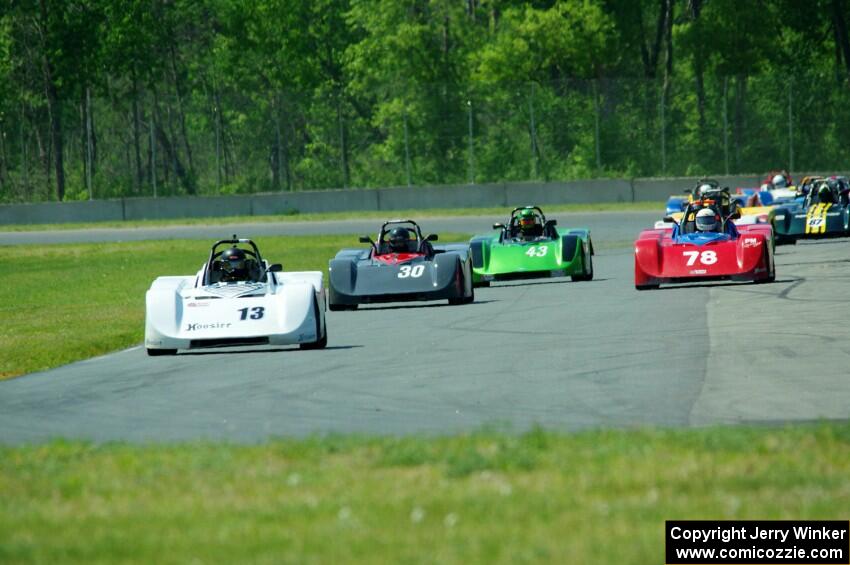 The field streams into turn four on the first lap.