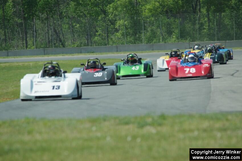 The field streams into turn four on the first lap.