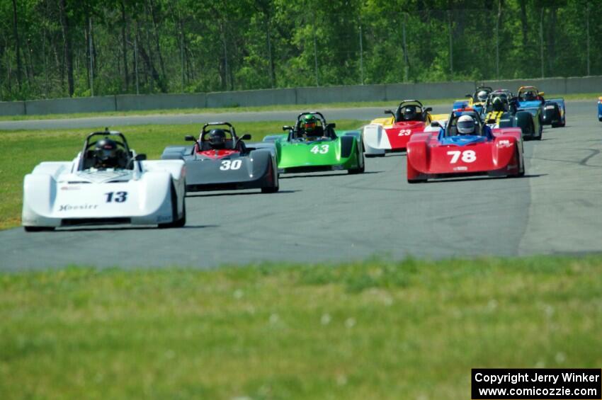 The field streams into turn four on the first lap.