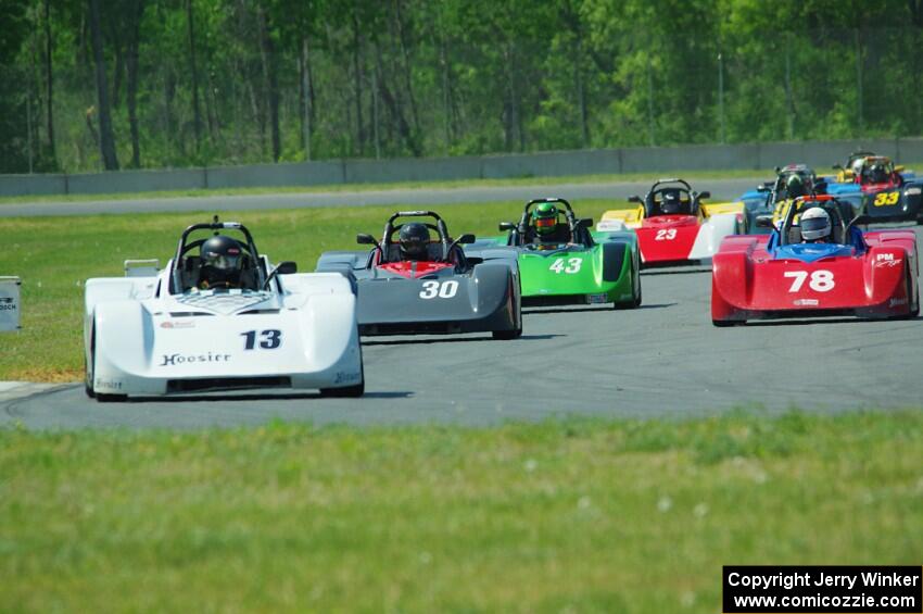 The field streams into turn four on the first lap.