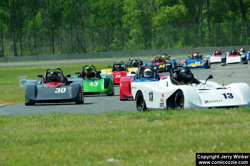 The field streams into turn four on the first lap.