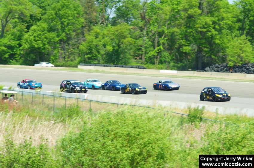 The Spec Miata and smaller production class field comes into turn 1 afier getting the green flag.
