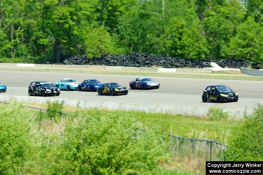 The Spec Miata and smaller production class field comes into turn 1 afier getting the green flag.