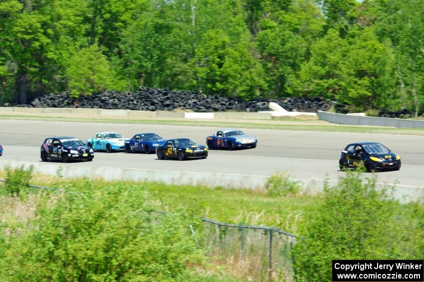 The Spec Miata and smaller production class field comes into turn 1 afier getting the green flag.