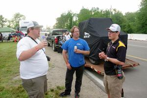 Ben Wedge, Brad Roettger and Patrick Palony chat on paddock road.