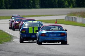 John Glowaski's STL Dodge Neon ACR and Rick Buan's Spec Miata Mazda Miata chase down the rest of the pack.