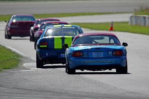 John Glowaski's STL Dodge Neon ACR and Rick Buan's Spec Miata Mazda Miata chase down the rest of the pack.