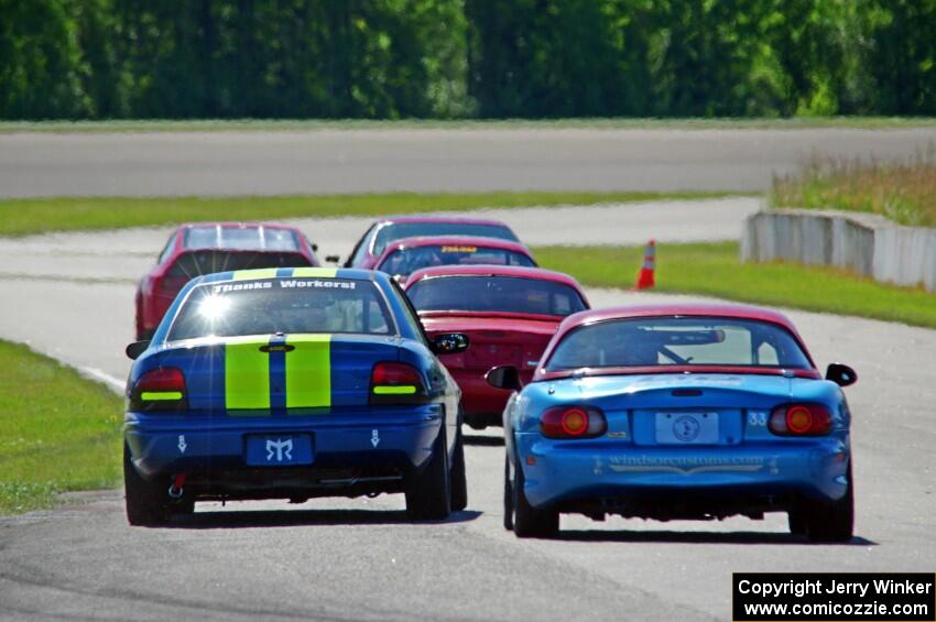 John Glowaski's STL Dodge Neon ACR and Rick Buan's Spec Miata Mazda Miata chase down the rest of the pack.