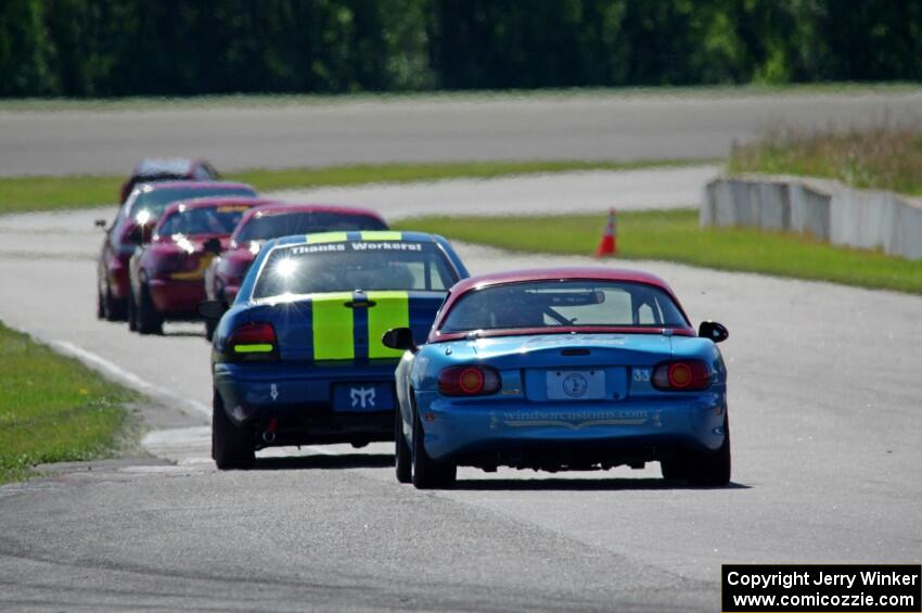 John Glowaski's STL Dodge Neon ACR and Rick Buan's Spec Miata Mazda Miata chase down the rest of the pack.