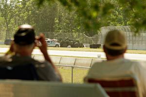 Two spectators view safety crews working at turn 3.