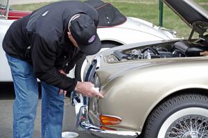 Dwight McCullough does last minute detailing on a Jaguar.